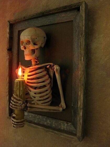 Halloween's Framed Skeleton Torso Wall Decor with Flashing Candle Bulb