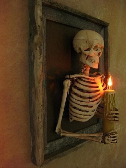Halloween's Framed Skeleton Torso Wall Decor with Flashing Candle Bulb